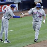 The Mets' Bartolo Colon (right) is greeted by third base coach Tim Teufel as he rounds the bases after hitting a two run home run against the Padres on Saturday in San Diego. Colon sets mark with homer in win