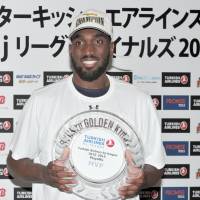 Ryukyu Golden Kings’ Evan Ravenel holds his award for playoff MVP after Sunday’s bj-league championship game win over the Toyama Grouses. Ryukyu's Ravenel named playoff MVP