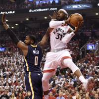 Raptors guard Terrence Ross looks to pass as Pacers forward C.J. Miles defends during the first half on Sunday in Toronto. Raptors survive rally to eliminate Pacers