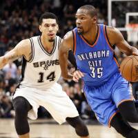 Oklahoma City’s Kevin Durant dribbles past San Antonio’s Danny Green in Game 2 on Monday night. The Thunder edged the Spurs 98-97 to tie the series. Thunder even series with Spurs despite Aldridge's 41