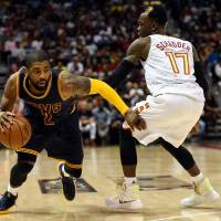 Cavaliers guard Kyrie Irving dribbles around Hawks guard Dennis Schroder during Game 4 on Sunday. Cavs sweep past Hawks to reach conference finals