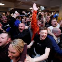 Leicester City fans celebrate at a local pub while watching Chelsea's 2-2 draw with Tottenham on Monday night. The result gave the Foxes the Premier League title and their first championship in 132 years. Leicester City completes miracle season with title