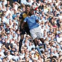 Manchester City’s Kelechi Iheanacho (right) and Arsenal’s Laurent Koscielny compete for the ball on Sunday. Manchester City's quest for Champions League spot takes hit with draw against Arsenal
