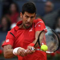 Novak Djokovic returns a ball to Kei Nishikori during the Madrid Open semifinal match on Saturday in the Spanish capital. Djokovic beat Nishikori 6-3, 7-6 (7-4). Djokovic downs Nishikori to set up final against Murray