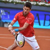 Novak Djokovic hits a shot during his match against Andy Murray in the Madrid Open final on Sunday. Djokovic defeated Murray 6-2, 3-6, 6-3. Djokovic beats Murray in Madrid for record 29th Masters title