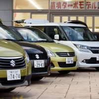 Vehicles are seen on display at a Suzuki Motor Corp. dealership in Yokohama in May. A new fuel economy testing method is set to be introduced in 2018. Japan to adopt international method for fuel-economy testing in 2018