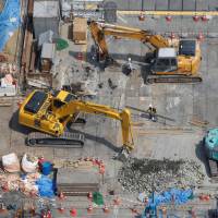 Heavy machinery is seen at a construction site in Tokyo on Wednesday. Japan's machinery orders fell 11% in April as the stronger yen spurred caution