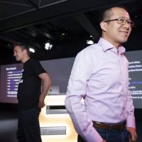 Finnish game company Supercell co-founder and CEO Ilkka Paananen (left) and Martin Lau, President of Tencent, face reporters at the company’s headquarters in Helsinki on Tuesday. SoftBank to sell stake in game developer Supercell to China's Tencent