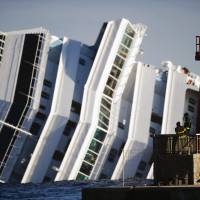 Firemen look at the side of the cruise liner Costa Concordia on Jan. 17, 2012. Disgraced Concordia Capt. Francesco Schettino lost his appeal on Tuesday against the 16-year jail sentence he was handed last February for his part in the Costa Concordia shipwreck, which killed 32 people. 16-year sentence stands for 'Captain Coward' in deadly sinking of Costa Concordia