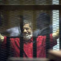 Former Egyptian President Mohammed Morsi, wearing a red jumpsuit that designates he has been sentenced to death, was sentenced on Saturday to 25 years in prison. He was ousted by the military in July 2013, and has already been sentenced to death in other cases. Egypt's former Islamist president sentenced to life in espionage trial
