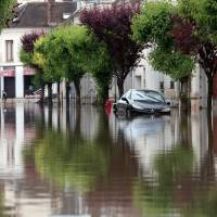 A car lays abandoned in a flooded street of Nemours, France, 80 km south of Paris, on Friday, June 3. Paris' flooded Seine River swells 6 meters: official