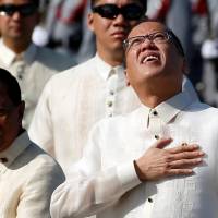 President Benigno Aquino III places his hand over his heart as he takes part in Independence Day celebrations in Manila on Sunday. Beside him is Vice President Jejomar Binay. In two weeks, Aquino will relinquish his post to President-elect Rodrigo Duterte. Ahead of handover to Duterte, Aquino implores Filipinos to safeguard their freedoms