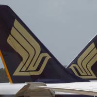 Singapore Airlines (SIA) planes sit on the tarmac in Singapore's Changi Airport in March. No injuries as Singapore Airlines jet catches fire in emergency landing