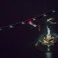Solar Impulse 2, the solar airplane, piloted by Swiss adventurer Andre Borschberg, flies over the Statue of Liberty in New York City on Saturday shortly before landing at John F. Kennedy airport. Globe-traveling solar-powered airplane lands in New York City