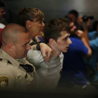 Police remove protester Michael Steven Sandford as Republican presidential candidate Donald Trump addresses a meeting at the Treasure Island hotel and casino in Las Vegas on Saturday. Sandford allegedly tried to steal a police officer’s gun in a bid to kill Trump. After planning for a year, Briton arrested in Las Vegas for trying to grab cop's gun to 'kill Trump'