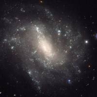 This image provided by NASA shows a barred spiral galaxy 130 million light-years away and is one of the measurements that astronomers used to come up with a faster rate of expansion of the universe. And if that new rate is correct, then scientists have to refigure some basic assumptions about the cosmos. Einstein may have been off as astronomers say universe expanding faster than forecast
