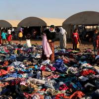 Displaced Iraqis from the Yazidi community look for clothes to wear among items provided by a charity organization at the Nowruz camp, in Derike, Syria, in this Aug. 12, 2014, file photo. IS still 'committing genocide' against Yazidis: U.N. probe