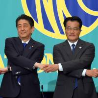 Prime Minister Shinzo Abe is flanked by Komeito chief Natsuo Yamaguchi (left) and Democratic Party President Katsuya Okada before Tuesday's public debate at the National Press Club in Tokyo. Abe plays economic card but opposition targets his 'hidden' agenda in Upper House election battle