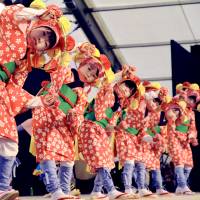 Children who evacuated from the town of Namie, Fukushima Prefecture, perform a folk dance at Izumo Taisha in Shimane Prefecture in May 2013. Fukushima child evacuees find hope in traditional folk dancing