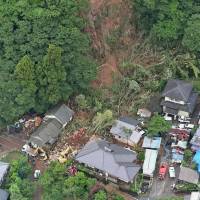 Workers and mechanical diggers toil away at the scene of a landslide in Uto, Kumamoto Prefecture, on Tuesday in this aerial photo. Heavy rain kills six in Kumamoto