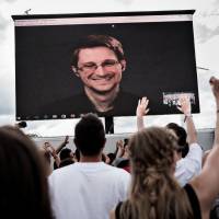 Rock star treatment: U.S. National Security Agency whistleblower Edward Snowden appears by video link at the Roskilde Festival in Denmark on Tuesday. Letters: Snowden and the sheeple; 'U.S. Marines culture' was once like Japan's