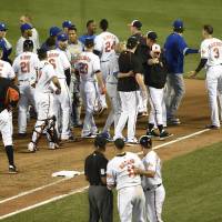 Players jostle each other on the field after Baltimore’s Manny Machado (foreground) was hit by a pitch by Kansas City’s Yordano Ventura during Tuesday’s game. The Orioles beat the Royals 9-1. Brawl mars Orioles victory