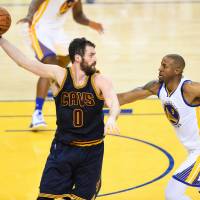 Cleveland's Kevin Love looks to pass as Golden State's Andre Iguodala defends during Game 1 of the NBA Finals on Thursday. Cavs looking to move ball in Game 2