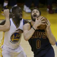 Cleveland's Kevin Love (right) takes on Golden State's Draymond Green during Game 2 on Sunday. Warriors, Cavs aware finals not done deal yet