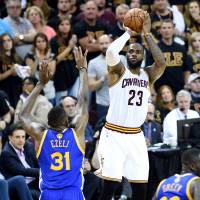 Cleveland's LeBron James shoots over Golden State's Festus Ezeli during Game 6 of the NBA Finals on Thursday. Cavs force decisive Game 7