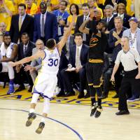 Cleveland's Kyrie Irving puts up the decisive shot over Golden State's Stephen Curry late in the fourth quarter of Game 7 on Sunday night. The Cavaliers downed the Warriors 93-89 to take the series 4-3. Cavaliers hold off Warriors to capture first NBA crown