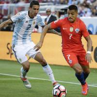 Chile's Alexis Sanchez (right) vies for the ball against Argentina's Angel Di Maria during their Copa America Group A match in Santa Clara, California, on Monday. Argentina won 2-1. Argentina edges Chile in rematch of Copa America final