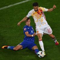 Croatia's Ivan Perisic (left) tackles Spain's Cesc Fabregas during their game at Euro 2016 on Tuesday. Croatia won 2-1. Croatia condemns Spain to Italy showdown at Euros