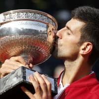 Novak Djokovic kisses the French Open trophy after winning his first title there by beating Andy Murray 3-6, 6-1, 6-2, 6-4 on Sunday in Paris. Djokovic finally wins French Open, completes career Grand Slam