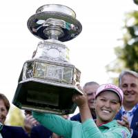 Brooke Henderson hoists the championship trophy after winning the KPMG Women's PGA Championship on Sunday in Sammamish, Washington. Henderson tops Ko in sudden-death playoff to claim KPMG Women's PGA Championship