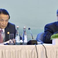 Finance Minister Taro Aso and U.S. Treasury Secretary Jack Lew attend a joint news conference after their talks Saturday in Chengdu, in China's Sichuan Province, on the sidelines of the Group of 20 meeting. Lew tells Aso currency devaluation war should be avoided