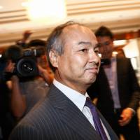 Masayoshi Son, chairman and chief executive officer of SoftBank Group Corp., leaves a news conference in London on Monday. Why SoftBank is spending ¥3.3 trillion on a U.K. chipmaker