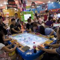 Computer culture: Customers play video games at an arcade in Kunming, Yunnan Province, China in 2011. The growth in China’s video game market means the country could soon become a major player in the industry. Video games may become China's best cultural export