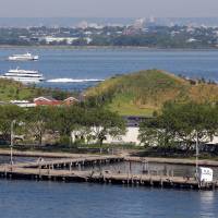 Two of the new mounds are visible on Governors Island, in New York Harbor, on July 6. Four new hills built on the island offer sweeping views of the Statue of Liberty, unique places to hike and climb, and massive slides that dwarf those found on any playground. New man-made hills on Governors Island in New York Harbor offer spectacular views
