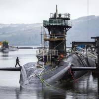 The Vanguard-class submarine HMS Vigilant, one of four Royal Navy submarines armed with Trident missiles, is seen at Naval Base Clyde, also known as Faslane, in Scotland in January. British lawmakers are due to vote Monday on whether to replace the fleet of nuclear-armed submarines. U.K. lawmakers set to debate replacing Britain's nuclear-armed submarines