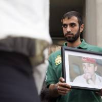 Nadeem Jeries holds a photo of Sammy Yatim, who he says was his best friend in high school, at a Toronto courthouse after the sentencing of Constable James Forcillo in Toronto on Thursday. Forcillo, a Toronto police officer, was sentenced to six years in the shooting death of Yatim in a case that sparked protests in Canada's largest city after it was caught on video and posted on YouTube. Race relations in spotlight in Canada as Montreal cop convicted in teen's shooting death caught on video