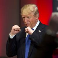 Republican U.S. presidential candidate Donald Trump poses with a ring given to him by a group of veterans during a campaign event on the campus of Drake University in Des Moines, Iowa, in January. For China, Trump perhaps better the devil they don't know