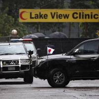 A Japanese envoy leaves after visiting the Holey Artisan Bakery and the O'Kitchen Restaurant, where an attack by gunmen had taken place, in Dhaka Sunday. Dhaka minister: Eatery gunmen made no demands, were from rich families, not Islamic State