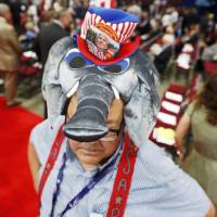 A convention goer wears a GOP mascot elephant hat at the Republican National Convention in Cleveland Monday. Romney, McCain, Bush among conspicuous no-shows at GOP fete to tap Trump