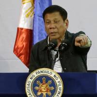 Philippine President Rodrigo Duterte delivers a speech at a solidarity dinner with the poor event at a slum area in Manila on June 30. Foreign Secretary Perfecto Yasay said Friday that Duterte's administration hoped to quickly begin direct talks with China following Tuesday's verdict on the contested South China Sea. Philippines willing to share South China Sea, says government