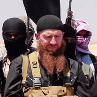This photo taken on July 3, 2014, allegedly shows Islamic State military leader Omar al-Shishani (center) speaking at an unknown location between Iraq's Nineveh province and the Syrian town of Al-Hasakah. Top Islamic State commander Shishani killed: jihadist-linked agency