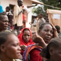 People wait to be registered Friday as displaced persons in a South Sudan Redcross compound in Wau. Amnesty report cites forced cannibalism, rape, death, trauma as South Sudan turns 5