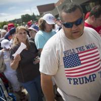 Attendees wait in line before the arrival of Republican Presidential candidate Donald Trump ahead of a campaign rally at the Sharonville Convention Center, Wednesday in Cincinnati. Jewish son-in-law says Trump is no racist or anti-Semite