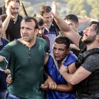 Turks on Istanbul's Bosporus Bridge apprehend a soldier who participated in the attempted military coup on Saturday. Turkey's bungled putsch: a strangely 20th century coup