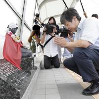 Seiji Shimomura, who lost his 2-year-old son in a fatal crush in Akashi, Hyogo Prefecture, in 2001, offers a prayer in front of a monument for the deceased on Friday. Legal wrangling ends over deadly Akashi crowd crush; ex-police deputy's acquittal upheld