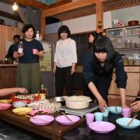 Female residents and friends prepare a meal at a share house in the village of Shirakawa, Gifu Prefecture. Gifu town looks to share-house initiative to meet depopulation challenge